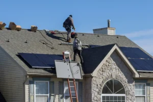 Roofer installing architectural shingles, a key factor in the new roof cost Wilmington NC homeowners pay
